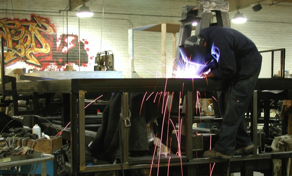 Fabrication with steel parade float chassis.